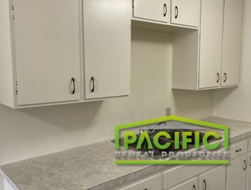 Ashland apartment for rent - a kitchen with white cabinets and a green logo