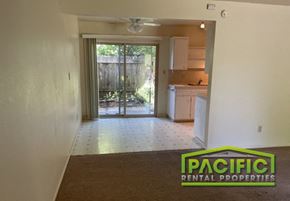 Ashland apartment for rent - an empty living room with a kitchen and a sliding glass door
