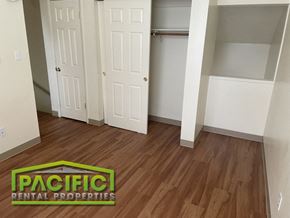 Medford apartment for rent - a renovated living room with wooden floors and a closet