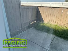 Central Point apartment for rent - a corner of a backyard with a fence and a sidewalk