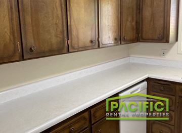 Ashland apartment for rent - a white counter top in a kitchen with wooden cabinets