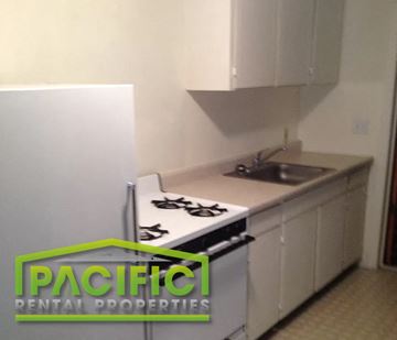 Ashland apartment for rent - a kitchen with a stove and a sink and a refrigerator