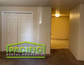 Medford apartment for rent - a living room with a white door and a landlord rental properties logo