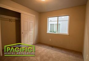Medford apartment for rent - the bedroom of an empty house with a closet and a window