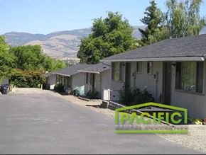Ashland apartment for rent - a row of houses with mountains in the background