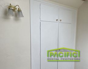 Ashland apartment for rent - a white cabinet with two lights and a sign on the wall