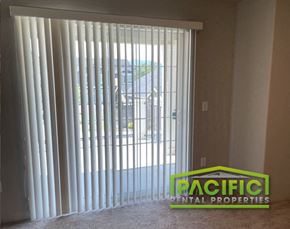 Medford apartment for rent - a sliding glass door with vertical blinds in a living room