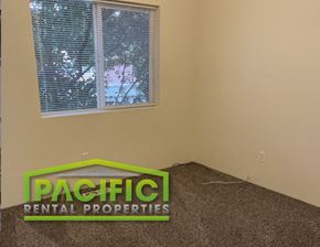 Medford apartment for rent - a bedroom with a window and a sign on the floor