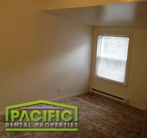 Ashland apartment for rent - an empty room with a window and a carpeted floor