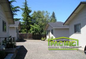 Ashland apartment for rent - a driveway in front of a white house and a backyard with trees
