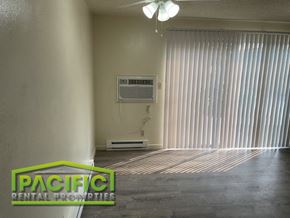 Medford apartment for rent - an empty living room with the air conditioner on the wall