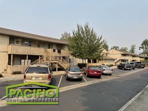 Medford apartment for rent - a parking lot with cars in front of an apartment building