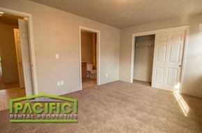 Medford apartment for rent - an empty living room with a carpeted floor and a closet
