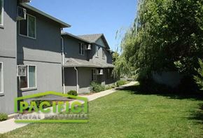 Medford apartment for rent - a green lawn in front of a gray house