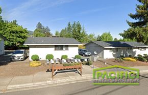 Ashland apartment for rent - an aerial view of a yard with a picnic table in front of a house