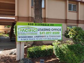 Medford apartment for rent - a sign for pacific leasing office in front of a building