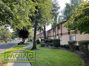 Medford apartment for rent - a building with trees and bushes in front of it