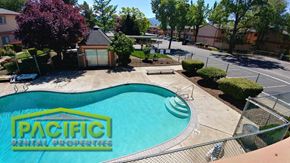 Medford apartment for rent - an aerial view of a swimming pool with a patta rental properties sign