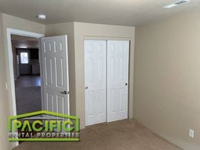 Central Point apartment for rent - a room with two closets and a door and a carpeted floor