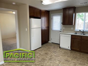 Central Point apartment for rent - a kitchen with a white refrigerator and a sink
