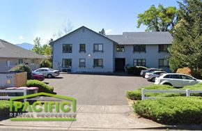 Phoenix apartment for rent - a large white building with cars parked in front of it