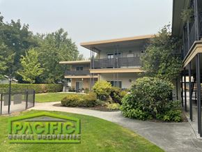 Medford apartment for rent - an apartment building with a yard and a sidewalk
