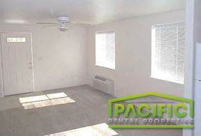 Central Point apartment for rent - an empty room with a ceiling fan and a door