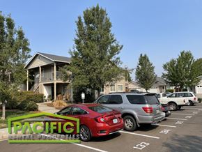 Medford apartment for rent - a parking lot filled with cars in front of a house
