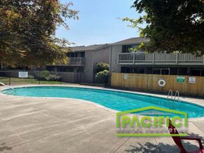 Medford apartment for rent - a swimming pool in front of an apartment building