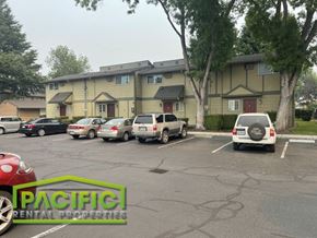 Medford apartment for rent - a parking lot with cars in front of a building