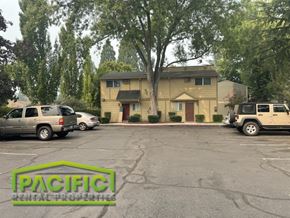 Medford apartment for rent - a parking lot with cars in front of a house