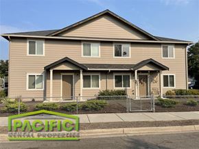 Medford apartment for rent - a tan house with a fence in front of it
