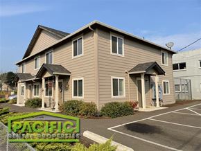 Medford apartment for rent - a tan and brown house with a parking lot
