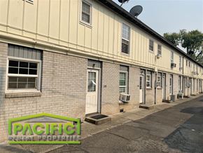 Medford apartment for rent - an old brick building with a pacific rental properties sign