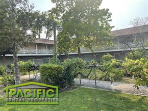 Medford apartment for rent - a building with a fence and a sign on the grass