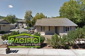 Rogue River apartment for rent - a small house with a sign in the front yard