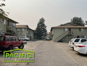 Medford apartment for rent - an empty parking lot with cars in front of apartment buildings