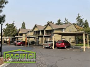 Ashland apartment for rent - a parking lot with cars in front of a building