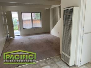 Ashland apartment for rent - an empty living room with a heater and a staircase