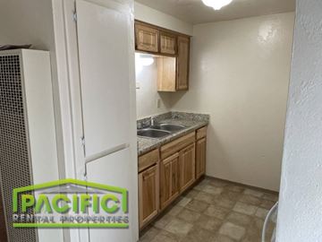 Ashland apartment for rent - a small kitchen with a refrigerator and a sink