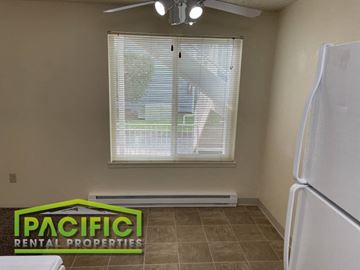 Ashland apartment for rent - a kitchen with a window and a white refrigerator