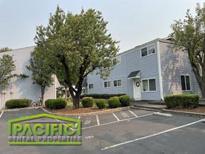 Ashland apartment for rent - a blue building with a tree in front of it in a parking lot