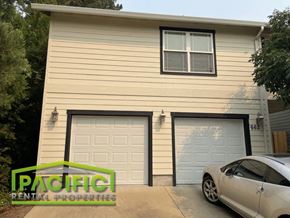Ashland apartment for rent - a house with two garage doors and a car parked in the driveway