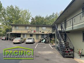 Ashland apartment for rent - a large apartment building with cars parked in a parking lot