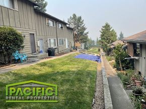 Ashland apartment for rent - a backyard with a blue tarp on the grass