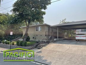Ashland apartment for rent - a house with a parking lot and a tree