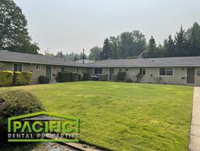 Ashland apartment for rent - a green lawn in front of a row of houses