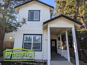 Ashland apartment for rent - a white house with a pacific real estate sign in front of it