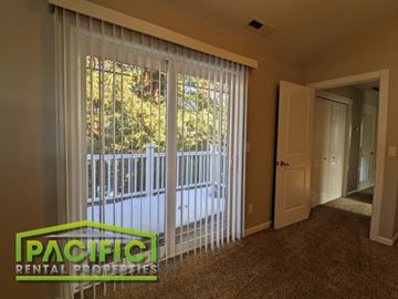 Ashland apartment for rent - a living room with a large window with white sheer curtains