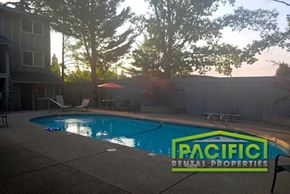 Medford apartment for rent - a swimming pool in a backyard with a rental properties logo